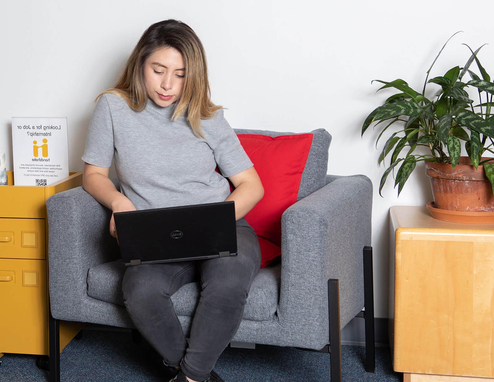 An SPU student looks through job postings on her laptop | photo by Lynn Anselmi